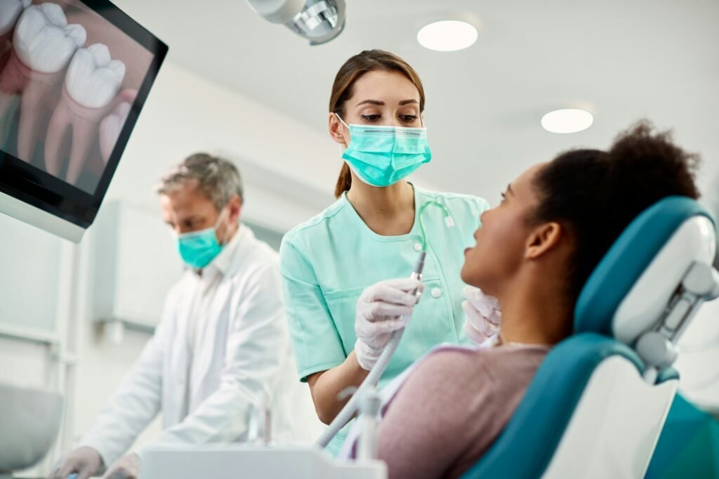 Dental team explaining how to maintain veneers bonding and whitened teeth